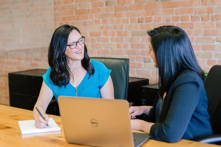 Two women in discussion in front of of computer