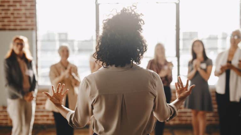 A woman is giving a presentation to a group of people.
