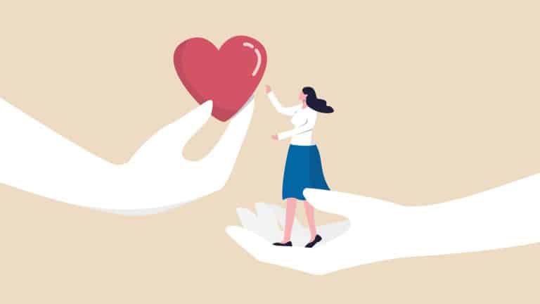 Empathy graphically illustrated by a hand offering a heart to a woman held up in another hand.