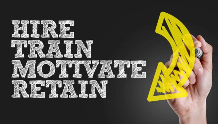 A hand draws a yellow arrow next to the words “Hire, Train, Motivate, Retain” on a black background.